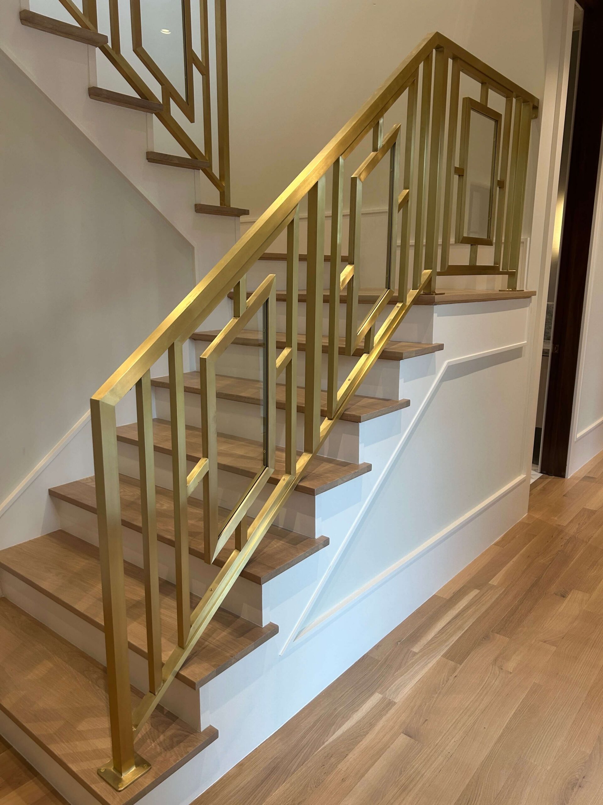 Modern staircase with brass geometric railing
